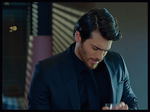 Man in Suit Holding Glass