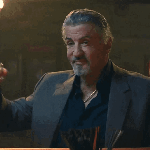 Man In Suit Holding Glass GIF