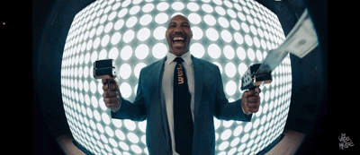 Man in Suit Holding Gun and Stack of Money