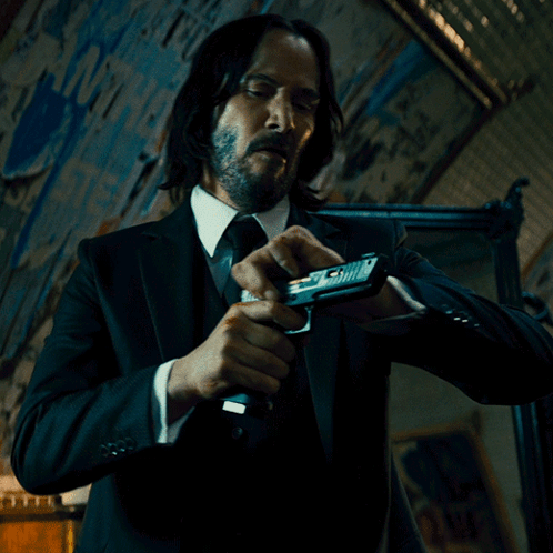 Man in Suit Holding Gun