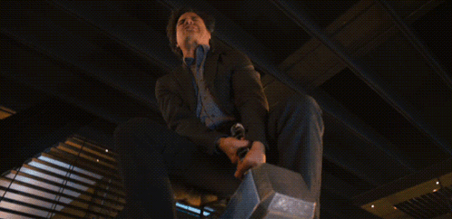 Man in Suit Holding Hammer