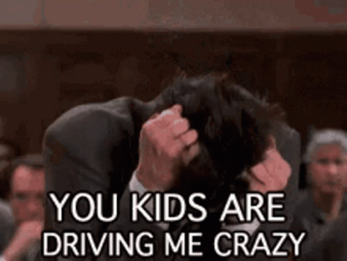 Man In Suit Holding Head Saying You Kids Are Driving Me Crazy GIF