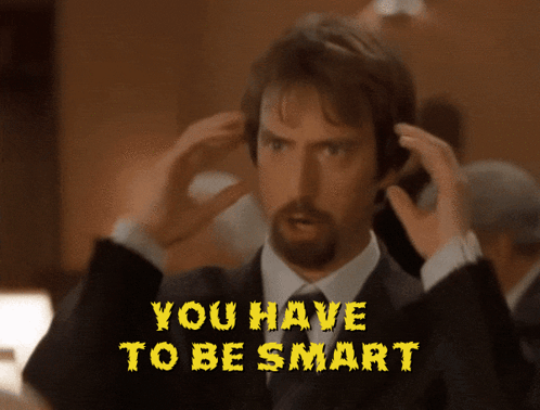 Man in Suit Holding Head You Have To Be Smart
