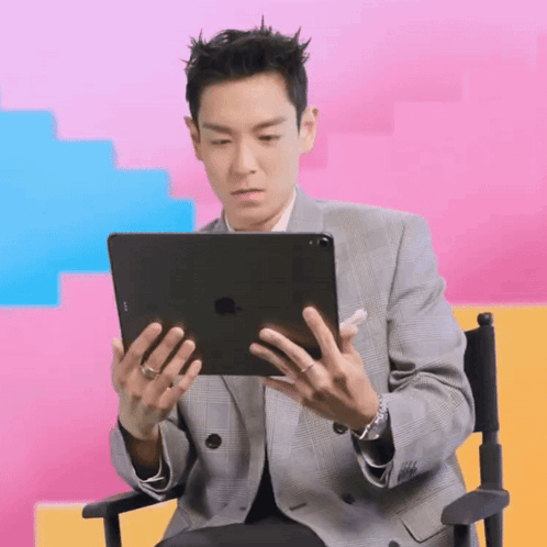 Man in Suit Holding iPad in Director's Chair