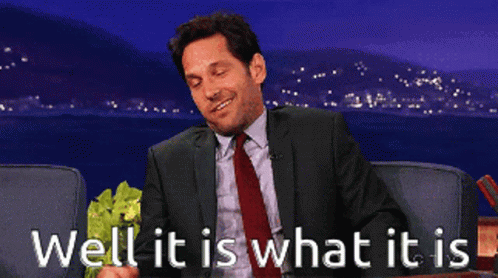 Man in Suit Holding Lettuce Saying Well It Is What It Is