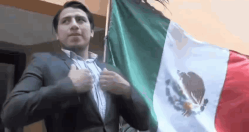 Man in Suit Holding Mexican Flag