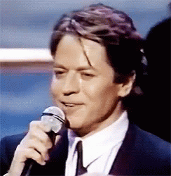 Man In Suit Holding Microphone GIF