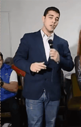 Man in Suit Holding Microphone