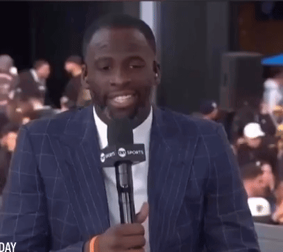 Man in Suit Holding Microphone
