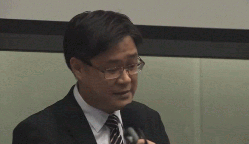 Man In Suit Holding Microphone GIF