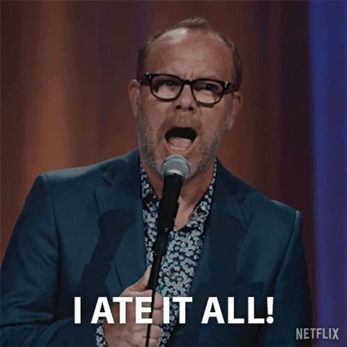 Man in Suit Holding Microphone Saying I Ate It All