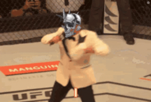 Man in Suit Holding Microphone Saying Its Timeeee