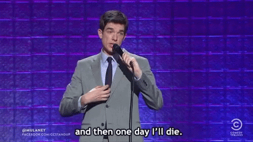 Man in Suit Holding Microphone Saying One Day I Will Die