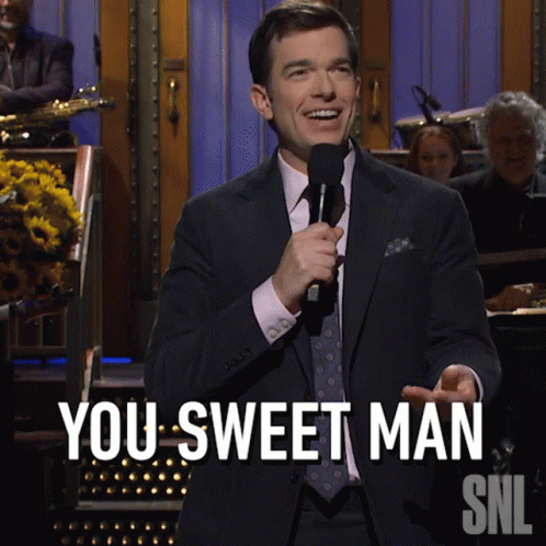 Man in Suit Holding Microphone Saying You Sweet Man