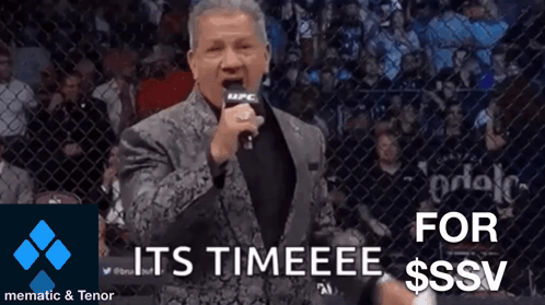 Man in Suit Holding Microphone Says Its Timeeee