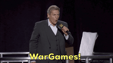 Man In Suit Holding Microphone Says Wargames GIF