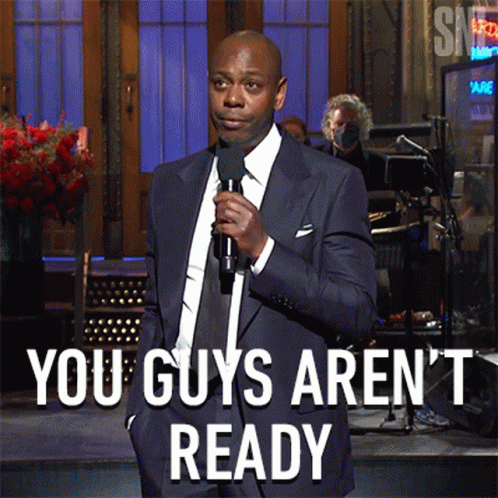 Man in Suit Holding Microphone Says You Guys Arent Ready