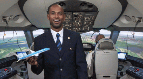 Man In Suit Holding Model Airplane GIF