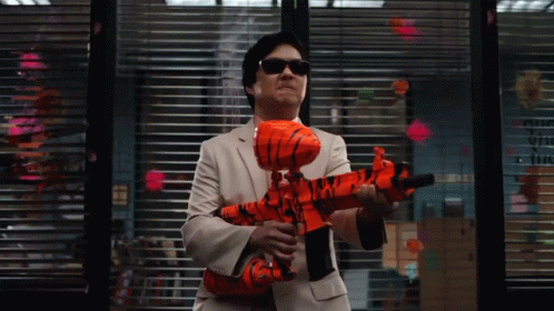Man In Suit Holding Orange Toy Gun By Window With Sticky Notes GIF