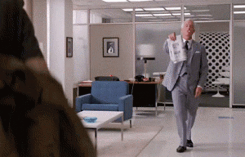 Man in Suit Holding Paper