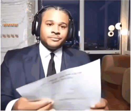 Man in Suit Holding Paper