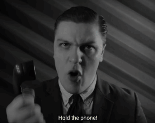 Man in Suit Holding Phone