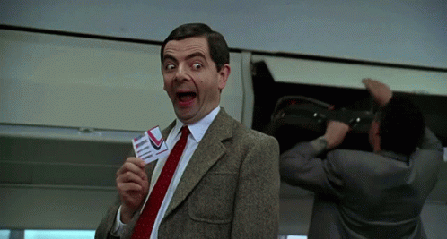 Man in Suit Holding Plane Ticket