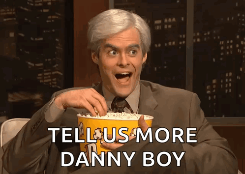 Man in Suit Holding Popcorn Tell Us More Danny Boy