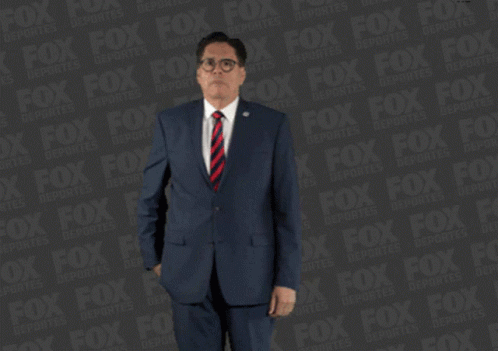 Man in Suit Holding Red Item by Fox Advertisement