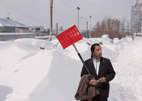 Man in Suit Holding Red Shovel