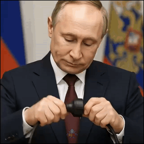 Man In Suit Holding Russia Text GIF