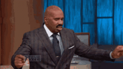 Man In Suit Holding Steve Harvey Card GIF