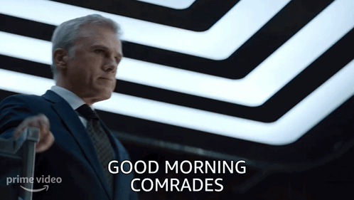 Man In Suit Holding Suitcase Saying Good Morning Comrades GIF