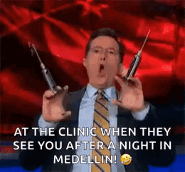 Man In Suit Holding Syringes GIF
