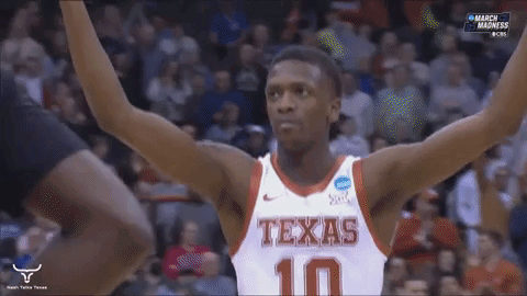 Man in Suit Holding Texas Sign