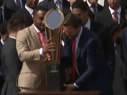 Man In Suit Holding Trophy GIF