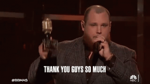 Man In Suit Holding Trophy Singing Into Microphone Saying Thank You Guys So Much GIF