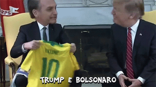 Man in Suit Holding Trump 10 Shirt