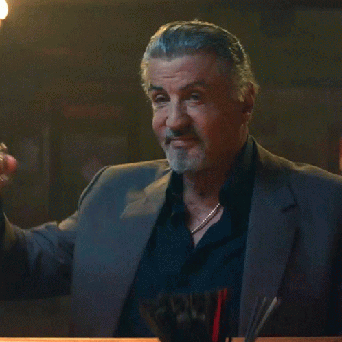 Man in Suit Holding Whiskey Glass