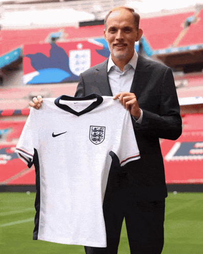 Man in Suit Holding White Nike Jersey