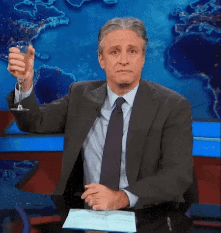 Man In Suit Holding Wine Glass In Front Of World Map GIF