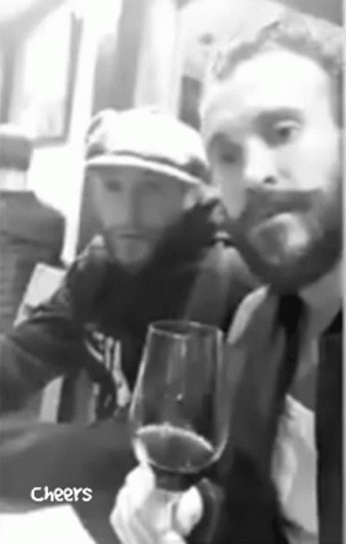 Man in Suit Holding Wine with Hat Man