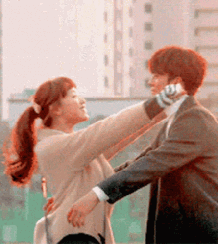 Man In Suit Holding Woman Talking On Phone GIF