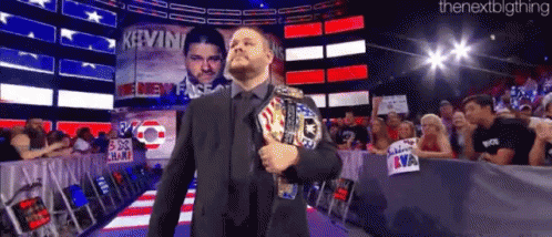 Man in Suit Holding World Heavyweight Championship Belt