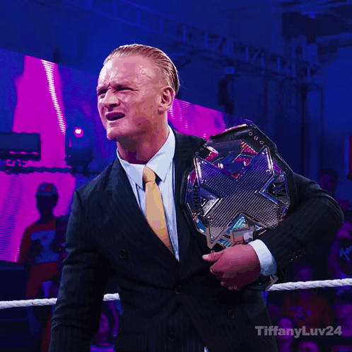 Man in Suit Holding Wrestling Championship