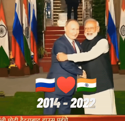 Man in Suit Hugging Another Man in Front of Flags 2014-2022