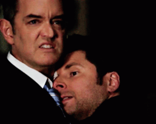 Man in Suit Hugging Another Man Saying Make It Tender