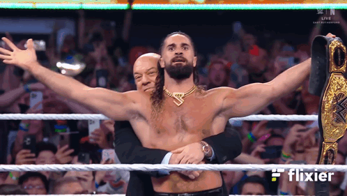 Man in Suit Hugging Man in Wrestling Ring Flixier
