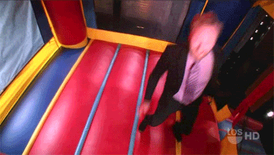 Man In Suit In Bouncy House GIF