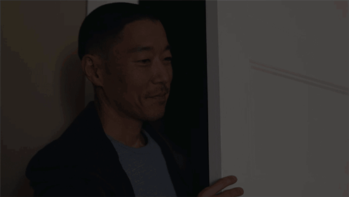 Man In Suit In Doorway GIF
